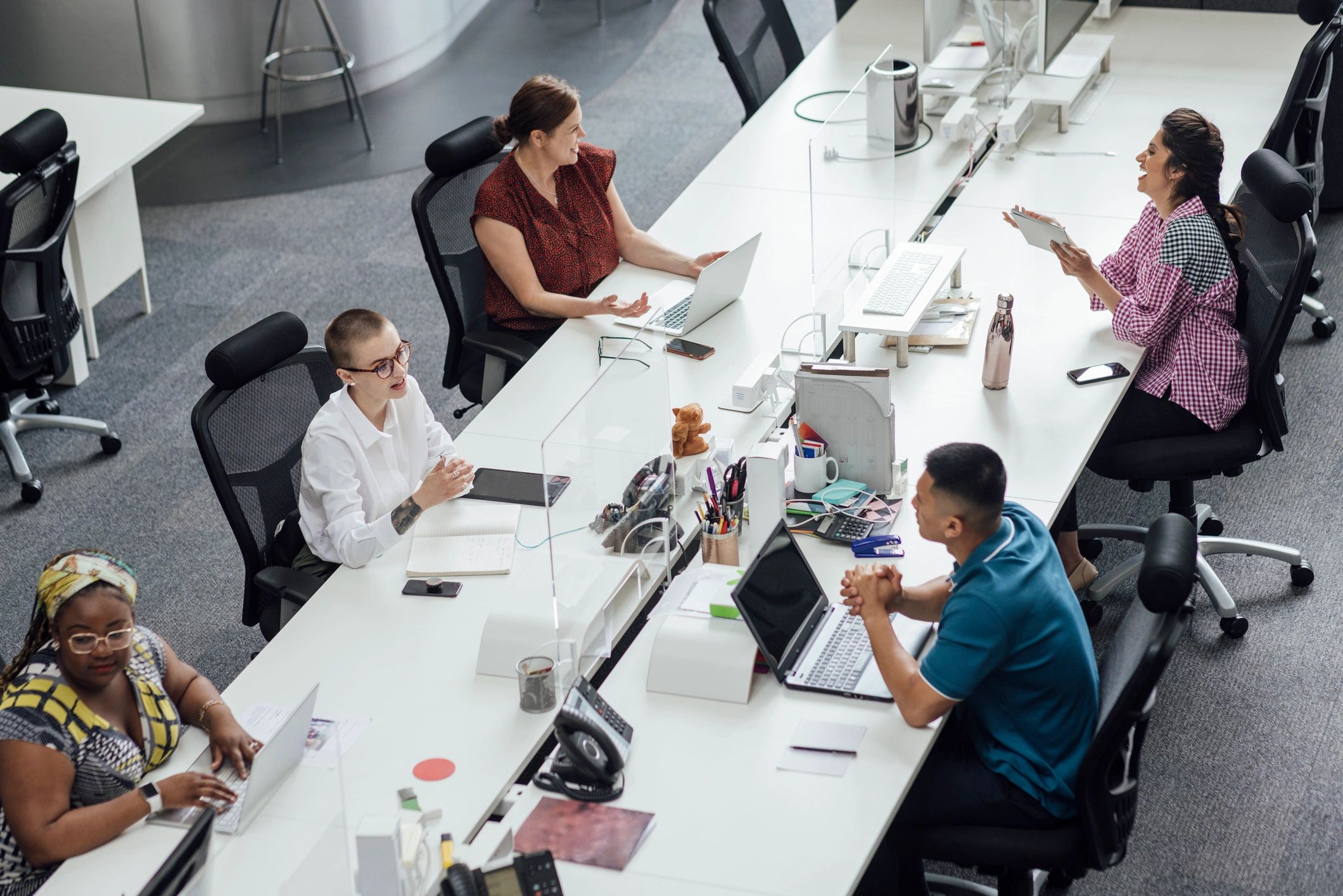 Journalists and editors working together in an open-plan newsroom
